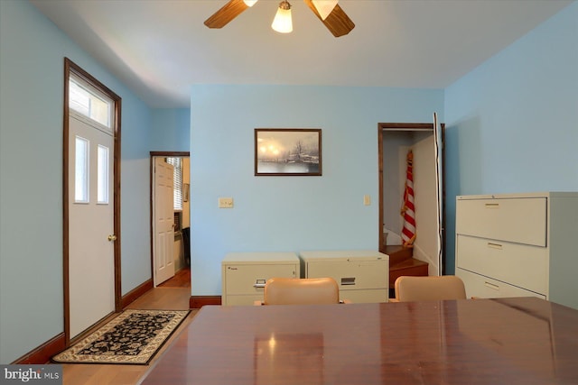 bedroom with wood finished floors, a ceiling fan, and baseboards