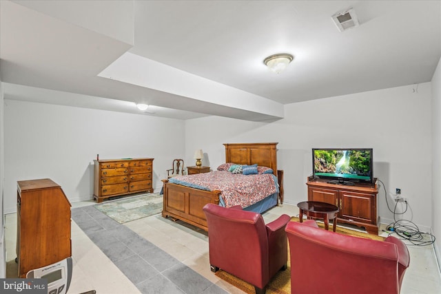 bedroom featuring baseboards and visible vents