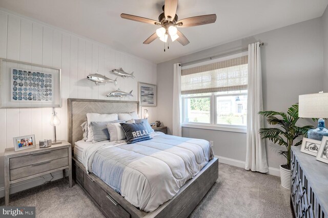 carpeted bedroom featuring ceiling fan and baseboards