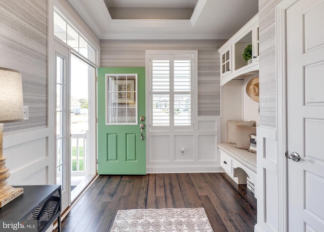 mudroom with dark wood-style flooring, crown molding, a decorative wall, and wallpapered walls