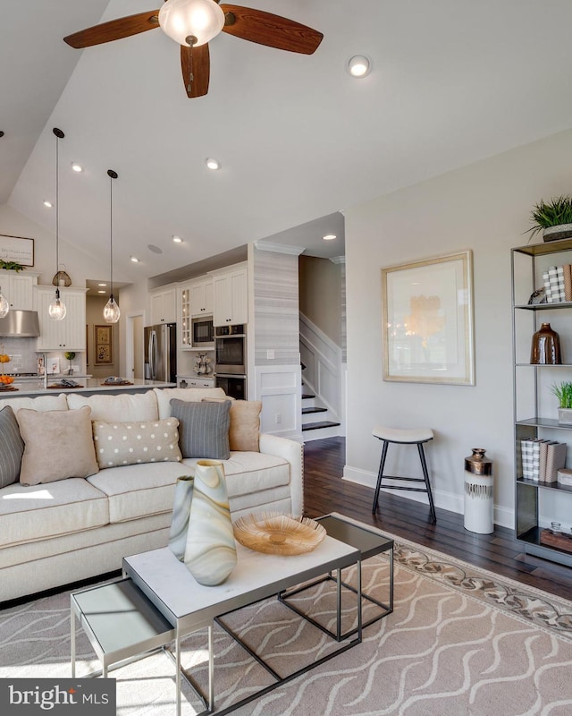 living area featuring lofted ceiling, dark wood-style flooring, stairway, and recessed lighting