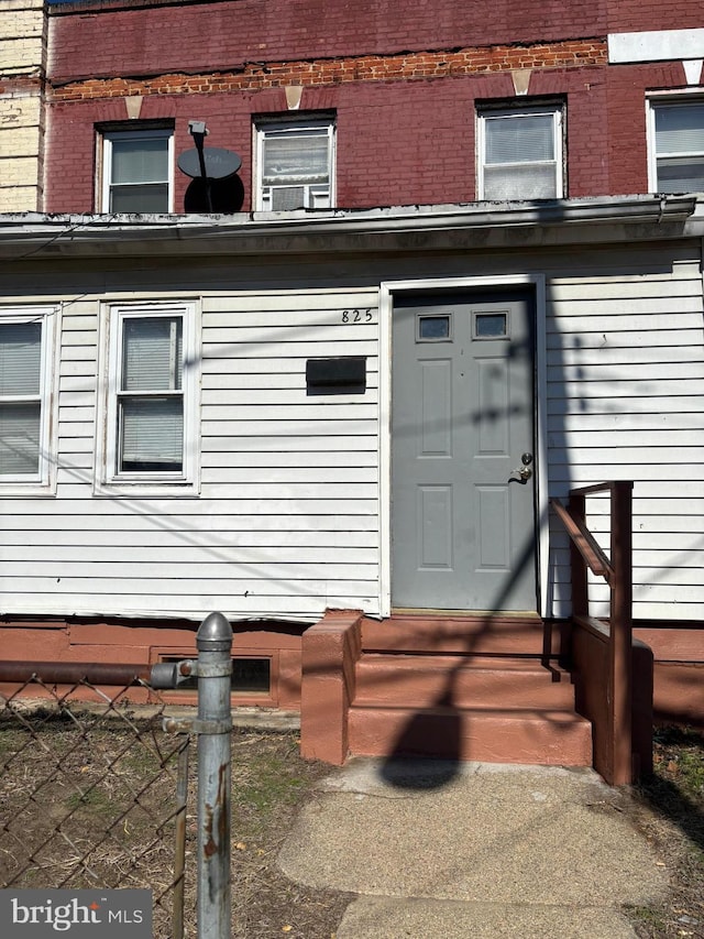 entrance to property featuring brick siding