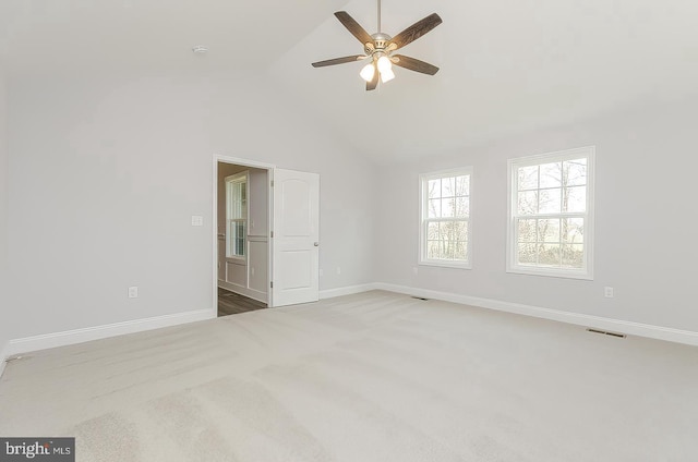 empty room with a ceiling fan, carpet flooring, high vaulted ceiling, and baseboards