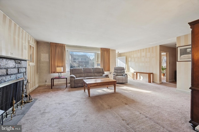 carpeted living area featuring a stone fireplace