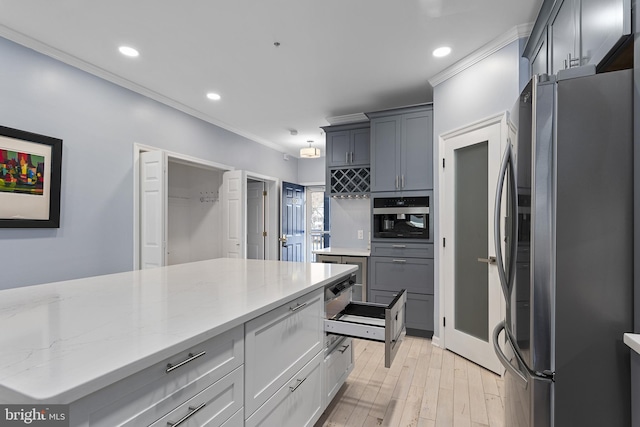 kitchen with ornamental molding, light stone counters, recessed lighting, appliances with stainless steel finishes, and light wood finished floors