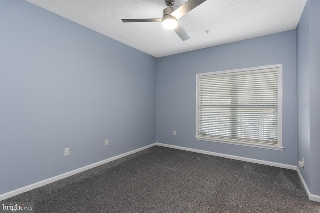 spare room with baseboards, a textured ceiling, ceiling fan, and dark carpet