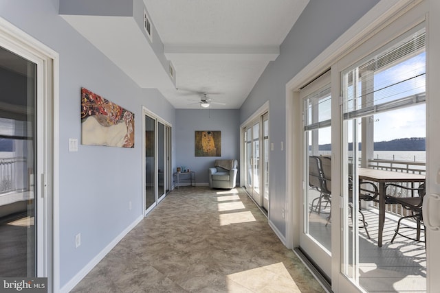 hallway featuring visible vents and baseboards