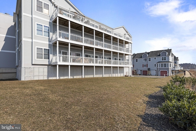 rear view of property featuring a lawn