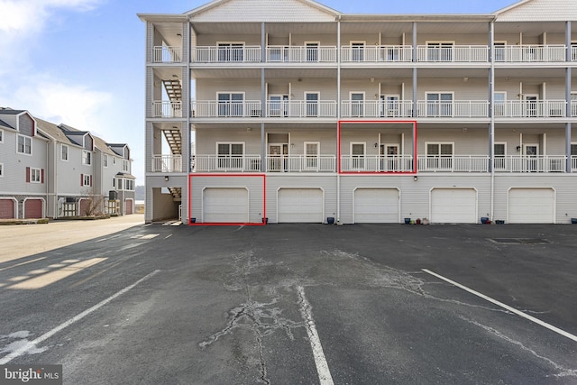 view of building exterior featuring driveway and an attached garage