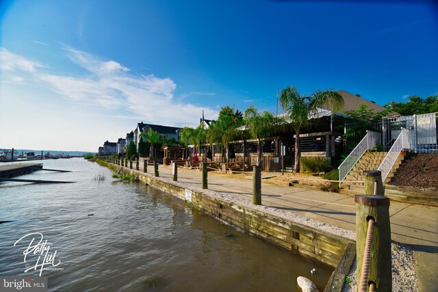 view of dock featuring stairs and a water view