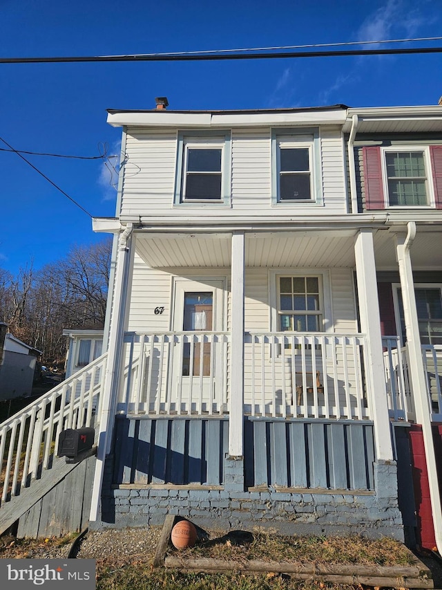 view of property featuring covered porch