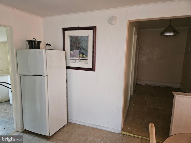 kitchen featuring freestanding refrigerator and crown molding