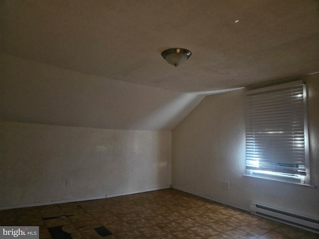 bonus room with vaulted ceiling and baseboard heating