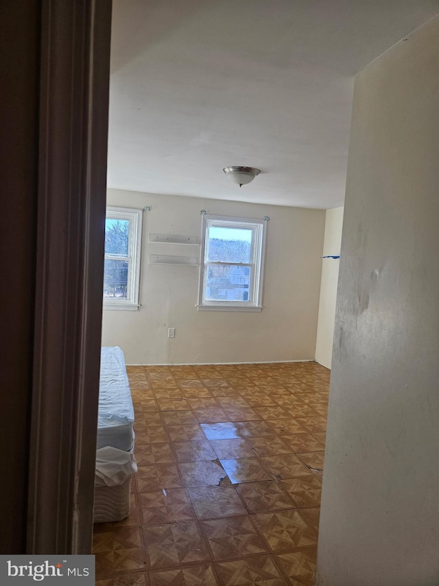 hallway with a healthy amount of sunlight and a wall unit AC