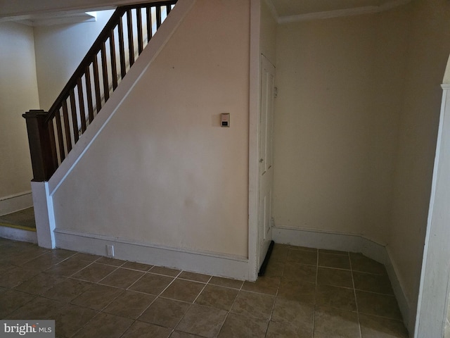 stairway featuring tile patterned flooring and baseboards