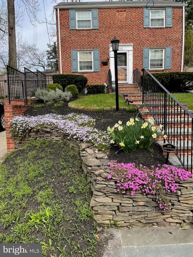 view of front of home featuring brick siding and entry steps