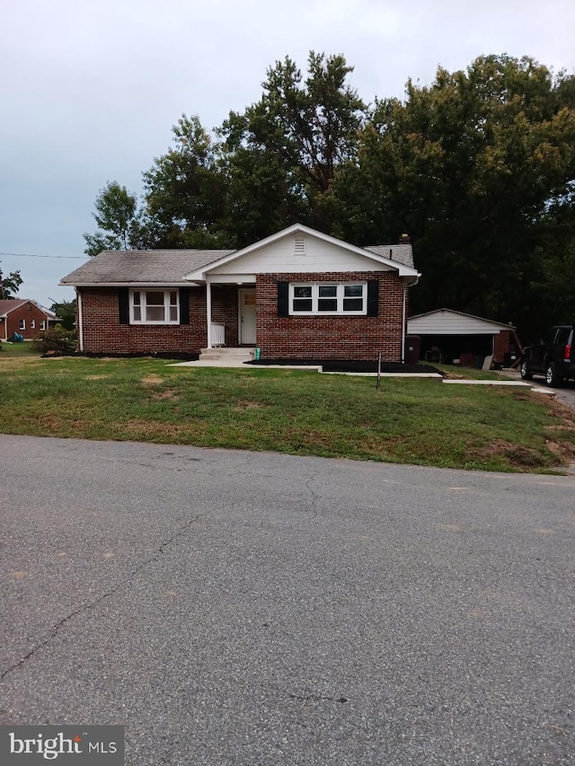 ranch-style home with brick siding and a front lawn