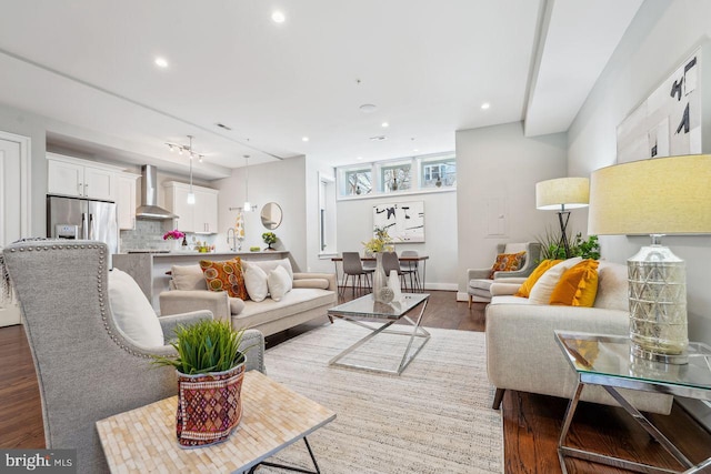 living room with dark wood-style floors, recessed lighting, and baseboards