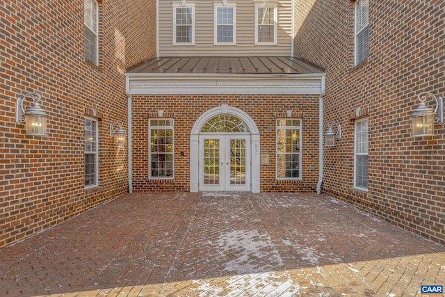 1051 Glenwood Station Ln Unit 405, Charlottesville, VA 22902 - doorway to property with french doors, brick siding, a patio, a standing seam roof, and metal roof