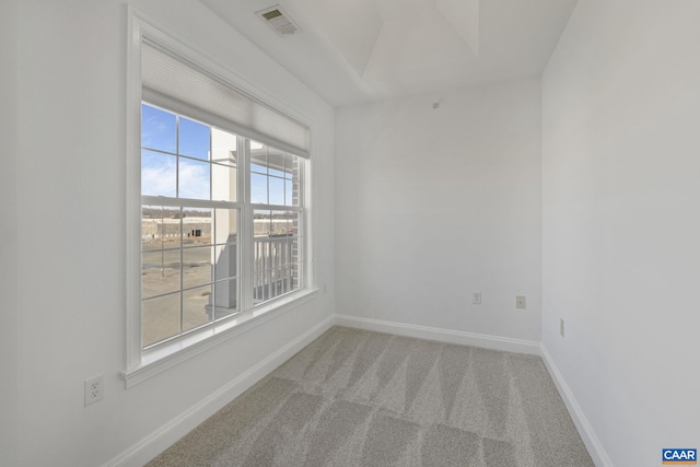 carpeted empty room with visible vents and baseboards