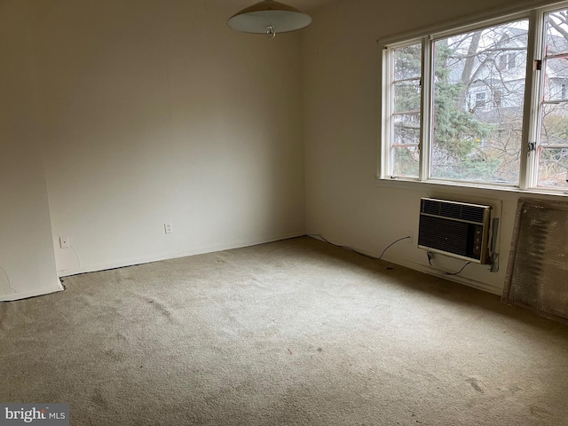 carpeted empty room featuring a wall mounted air conditioner