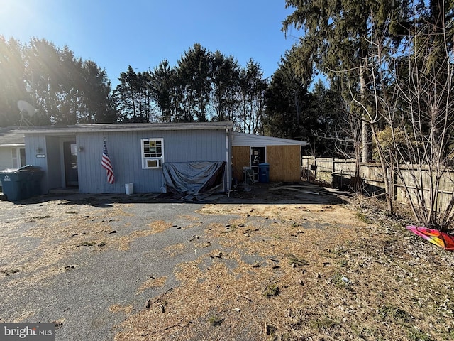 back of property featuring fence