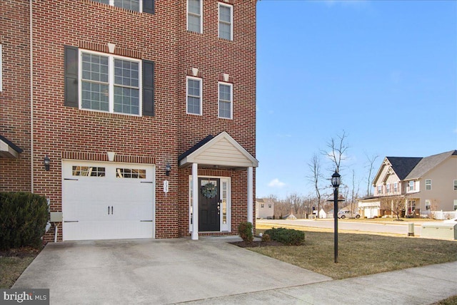 view of front of home with a garage, driveway, brick siding, and a residential view