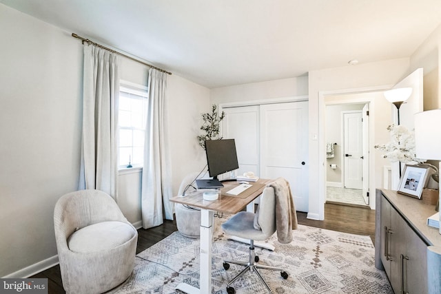 office featuring baseboards and wood finished floors