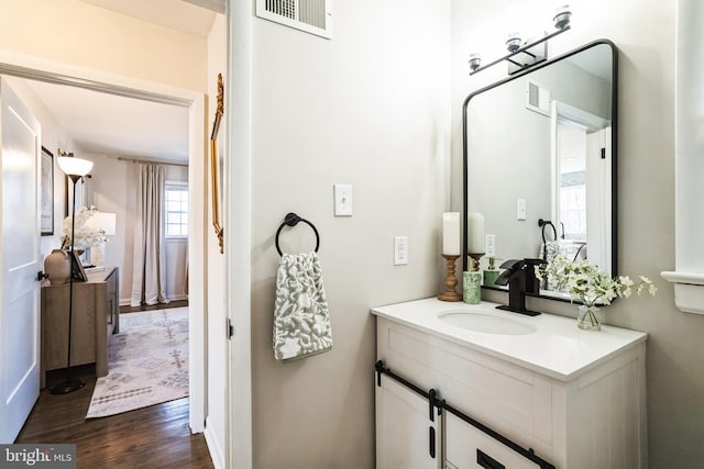 bathroom featuring vanity, wood finished floors, and visible vents