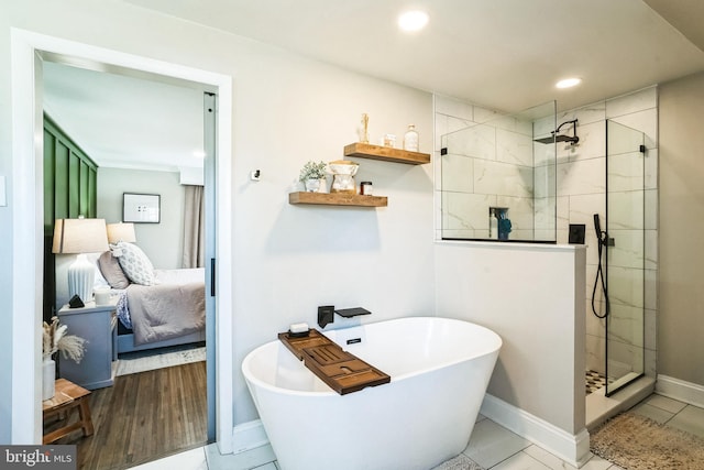 ensuite bathroom featuring ensuite bathroom, recessed lighting, baseboards, a soaking tub, and walk in shower