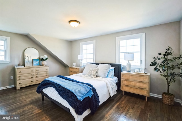 bedroom with baseboards and wood finished floors