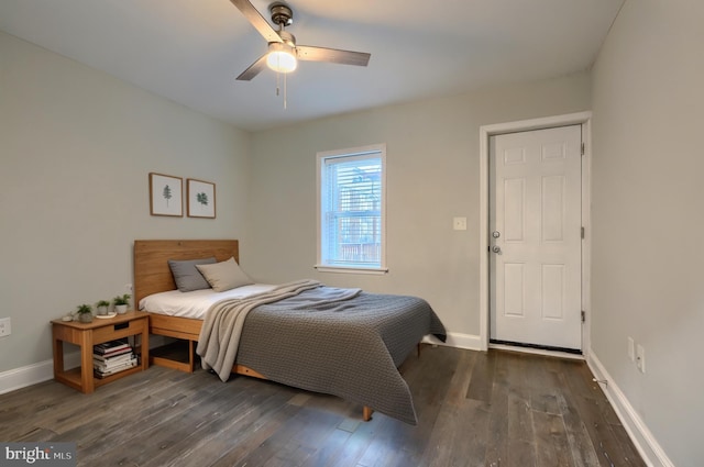 bedroom featuring a ceiling fan, wood finished floors, and baseboards