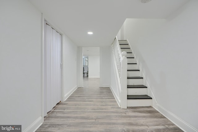 stairs featuring recessed lighting, baseboards, and wood finished floors