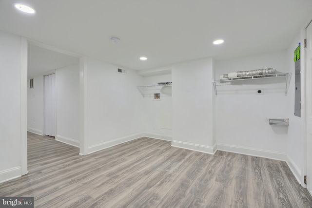 spare room with recessed lighting, wood finished floors, and baseboards