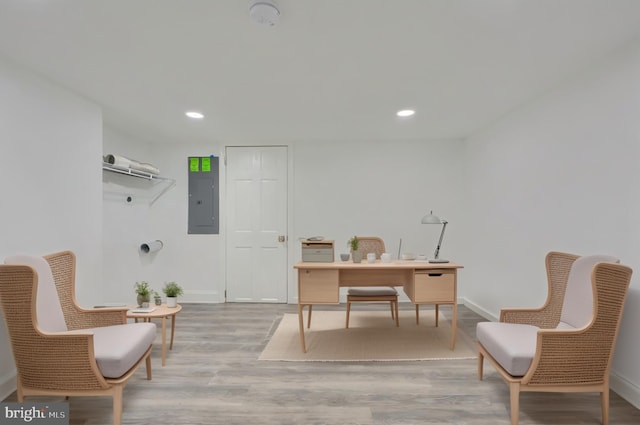 office featuring electric panel, wood finished floors, recessed lighting, and baseboards