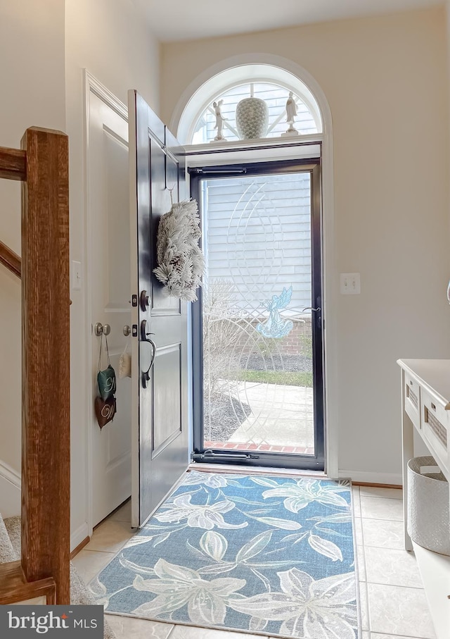 foyer entrance with light tile patterned floors