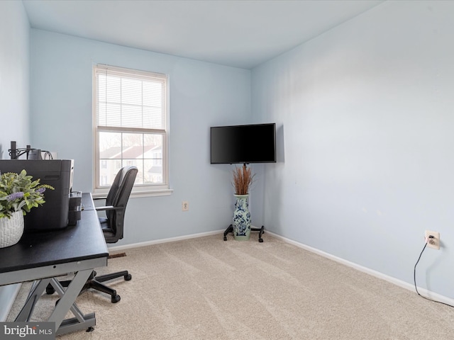 home office featuring baseboards and carpet