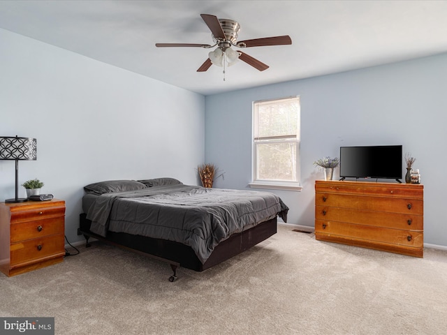 bedroom with a ceiling fan, carpet, and baseboards