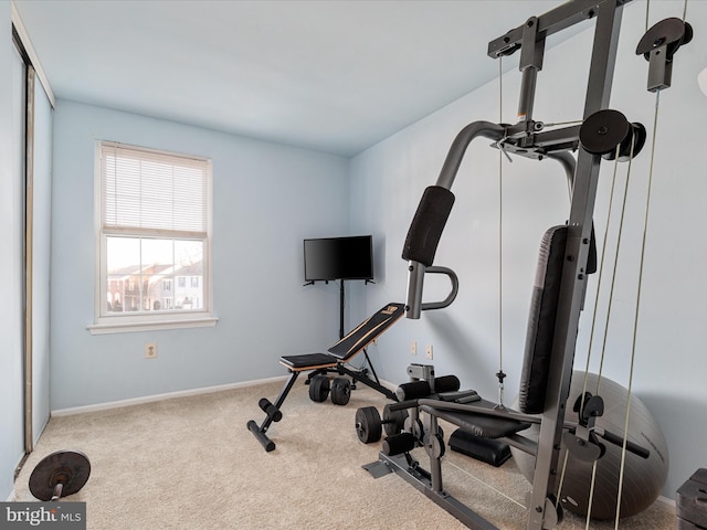 workout room with baseboards and carpet flooring