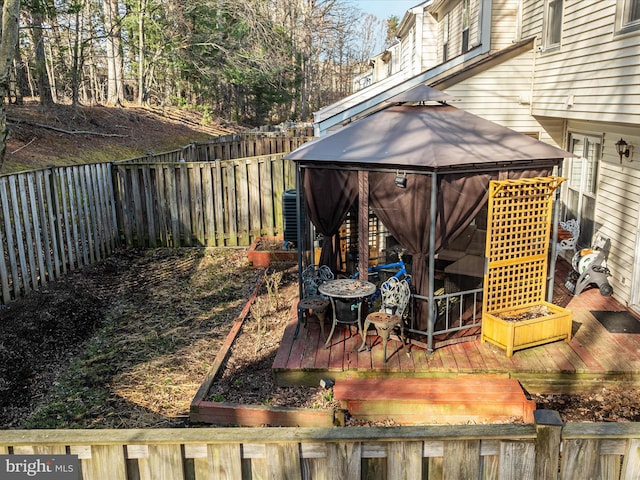 view of yard featuring a deck, a gazebo, and a fenced backyard