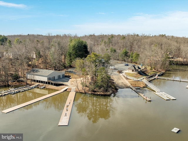 aerial view with a wooded view and a water view