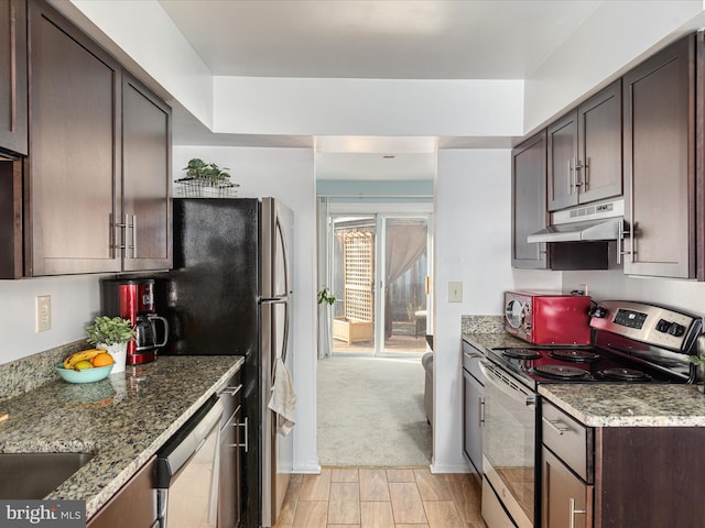 kitchen featuring dishwashing machine, light stone counters, electric range, dark brown cabinetry, and under cabinet range hood