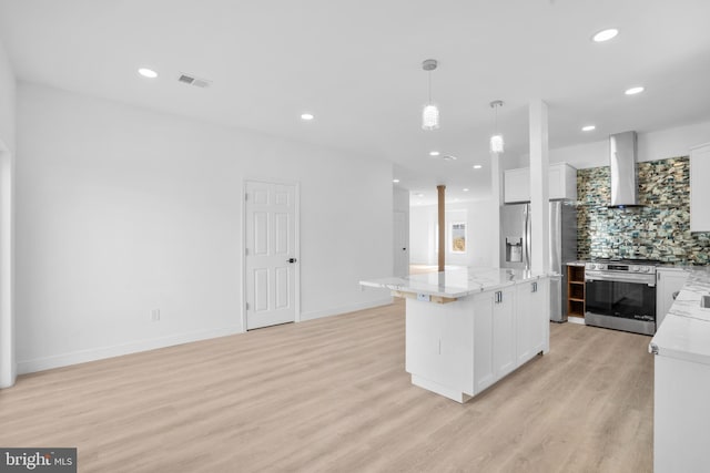 kitchen with visible vents, tasteful backsplash, light wood-style floors, appliances with stainless steel finishes, and wall chimney exhaust hood