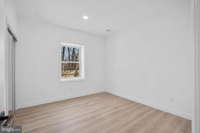 unfurnished bedroom featuring recessed lighting, baseboards, and light wood finished floors