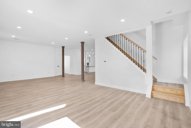 unfurnished living room featuring stairway, recessed lighting, light wood-type flooring, and baseboards