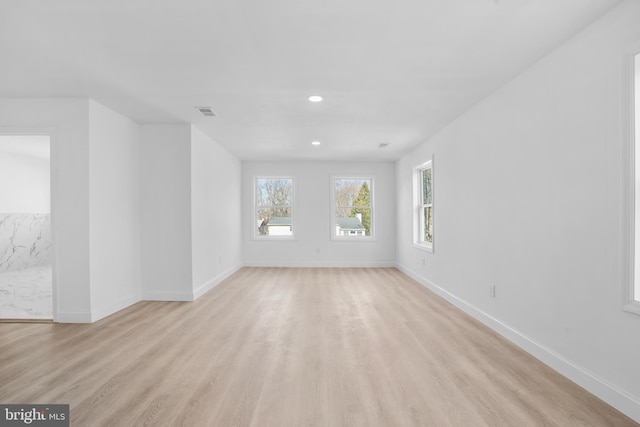 unfurnished room with recessed lighting, light wood-style floors, and baseboards