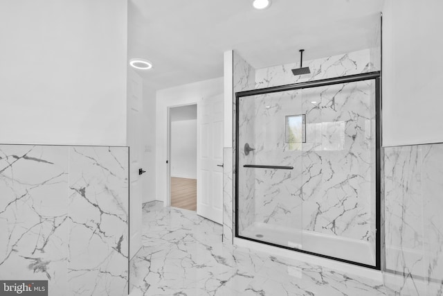 bathroom featuring a marble finish shower and marble finish floor