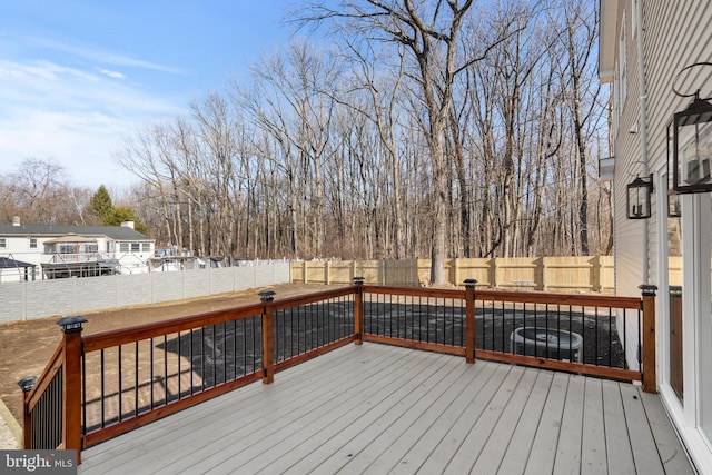 wooden terrace featuring cooling unit and a fenced backyard