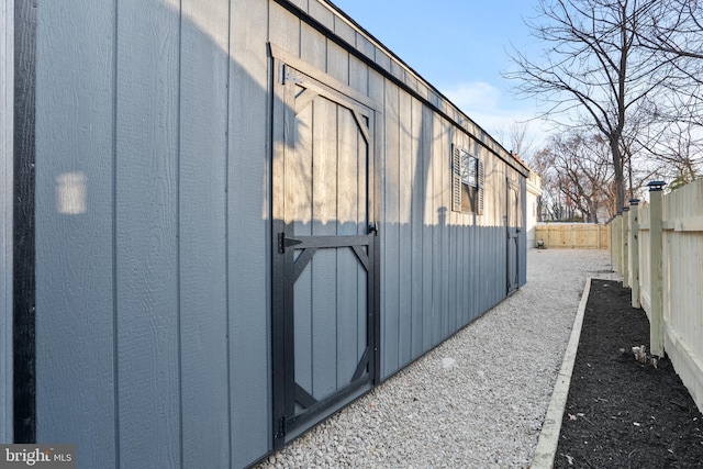 view of outdoor structure featuring an outbuilding and a fenced backyard