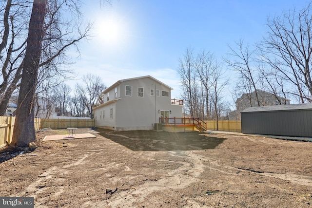 back of property with a patio, an outbuilding, and a fenced backyard